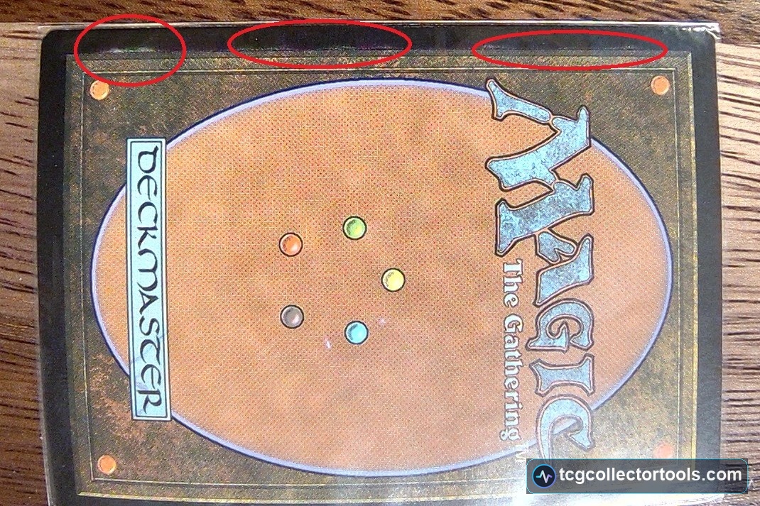 Genuine Magic card back with rough, uneven printing along the top border marked by red circles.