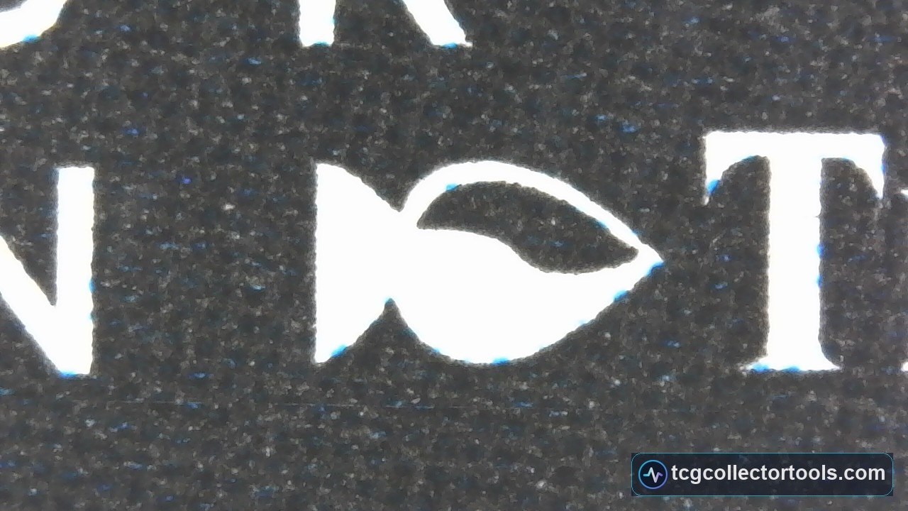 Macro of the author stamp on a counterfeit Magic card, showing colored dots in the black print and no repeating teeth pattern.