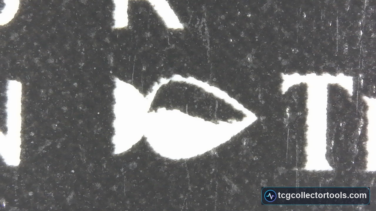 Macro of the author stamp on a genuine Magic card, showing solid black print and a repeating teeth pattern around the white lettering.