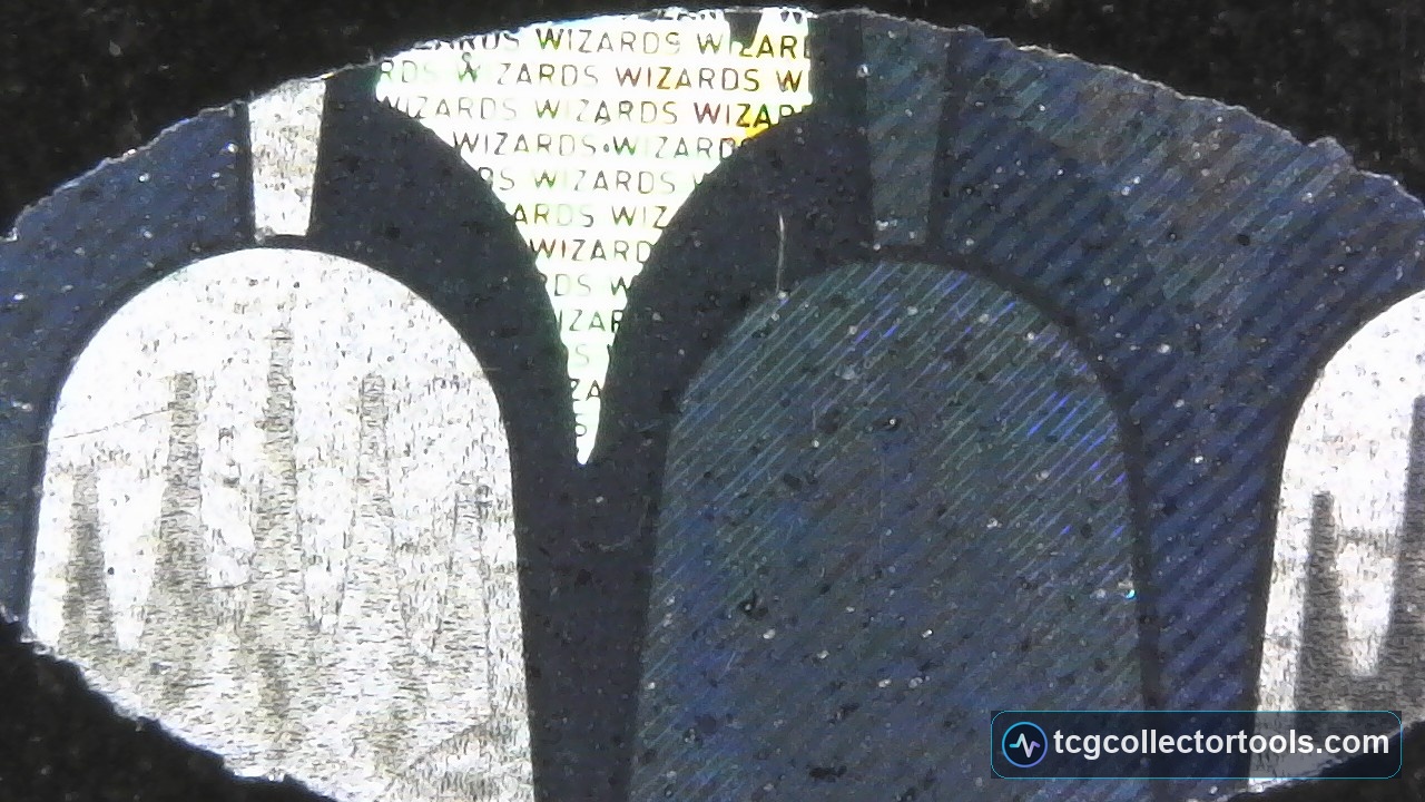 Extreme macro of a genuine Magic hologram showing repeated tiny 'WIZARDS' microtext and fine directional line texture.